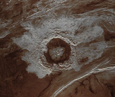 Dickinson Crater (possible Natural Colors; credits: Dr Paolo C. Fienga - Lunexit Team)
This Magellan image is centered at 74,6° North Latitude and 177,3° East Longitude, in the North/Eastern Atalanta Region of Venus. 
The image is approximately 185 Km (about 115 miles) wide at the base, and shows Dickinson, an Impact Crater of about 69 Km (approx. 43 miles) in diameter. The Crater is complex, characterized by a partial Central Ring and a Floor flooded by radar-dark and radar-bright materials. 
Hummocky, rough-textured ejecta extend all around the Crater, except to the West. The lack of ejecta to the West may indicate that the Impactor that produced the Crater reached the Surface on an oblique angle, and from the West. 

Extensive radar-bright flows that emanate from the Crater's Eastern Walls may represent large volumes of impact melt, or they may be the result of volcanic material released from the Subsurface during the cratering event.
Parole chiave: Venus from orbit - Craters - Dickinson Crater