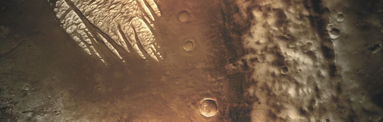 Pollack Crater and "White Rock" (Slightly Saturated Absolute Natural Colors; credits for the additional process. and color.: Dr Paolo C. Fienga - Lunexit Team)
Caption NASA:"White Rock is the unofficial name for this unusual landform which was first observed during the Mariner 9 Mission in the early 70's. As later analysis of additional data sets would show, White Rock is neither white nor dense rock. Its apparent brightness arises from the fact that the material surrounding it is so dark. Images from the Mars Global Surveyor MOC camera revealed dark sand dunes surrounding White Rock and on the floor of the troughs within it. 
Some of these dunes are just apparent in the THEMIS image. Although there was speculation that the material composing White Rock could be salts from an ancient dry lakebed, spectral data from the MGS TES instrument did not support this claim. Instead, the White Rock deposit may be the erosional remnant of a previously more continuous occurrence of air fall sediments, either volcanic ash or windblown dust. 
The THEMIS image offers new evidence for the idea that the original deposit covered a larger area. 

Approximately 10 Km to the South-East of the main deposit are some tiny knobs of similarly bright material preserved on the floor of a small crater. Given that the eolian erosion of the main White Rock deposit has produced isolated knobs at its edges, it is reasonable to suspect that the more distant outliers are the remnants of a once continuous deposit that stretched at least to this location. 
The fact that so little remains of the larger deposit suggests that the material is very easily eroded and simply blows away".
Parole chiave: Mars from orbit - Craters - Pollack Crater