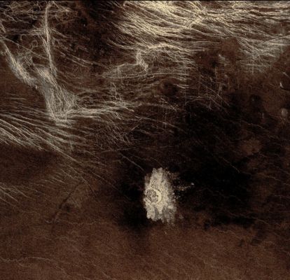 Stephania Crater (possible Natural Colors; credits: Dr Paolo C. Fienga - Lunexit Team)
Crater Stephania is located at 51,3° Norh Latitude and 333,3° East Longitude in Northern Sedna Planitia. 

With a diameter of about 11 Km (6,8 miles), Stephania is one of the smaller Craters on Venus. 
Because many small meteoroids disintegrate during their passage through the dense Venusian atmosphere, there is an absence of craters smaller than 3 Km (approx. 1,9 miles) in diameter, and even craters smaller than 25 Km (15,5 miles) are relatively scarce. 

The apron of ejected material suggests that the impacting body made contact with the Surface from an oblique angle. Upon closer observation it is possible to delineate secondary craters, impact scars from blocks ejected from the primary crater. 
A feature associated with this and many other Venusian Craters is a radar-dark halo. 
Since dark radar return signifies a smooth surface, it has been hypothesized that an intense shock wave removed or pulverized previously rough surface material or that a blanket of fine material was deposited during or after the impact.
Parole chiave: Venus from orbit - Craters - Stephania Crater