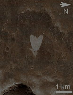 Martian "Love" (EDM - Absolute Natural Colors; credits for the additional process. and color.: Dr Paolo C. Fienga - Lunexit Team)
This picture of a "heart-shaped" feature in Arabia Terra on Mars was taken on May 23, 2010, by the Context Camera (CTX) on NASA's Mars Reconnaissance Orbiter. A small Impact Crater near the tip of the heart is responsible for the formation of the bright, heart-shaped feature. When the impact occurred, darker material on the Surface was blown away while brighter material beneath it was revealed. 

Some of this brighter material appears to have flowed further downslope to form the heart, as the small impact occurred on the Ejecta Blanket of a much larger Impact Crater. 

The heart-shaped feature is about 1 Km (0,6 mile) long and is centered at 21,9° North Lat. and 12,7° West Long. 

These pictures are subframes of the full CTX image B21_017910_2002_XI_20N012W, taken just at the start of northern summer on Mars. North is to the right, and illumination is from the upper right.
Parole chiave: Mars from orbit - Arabia Terra Region