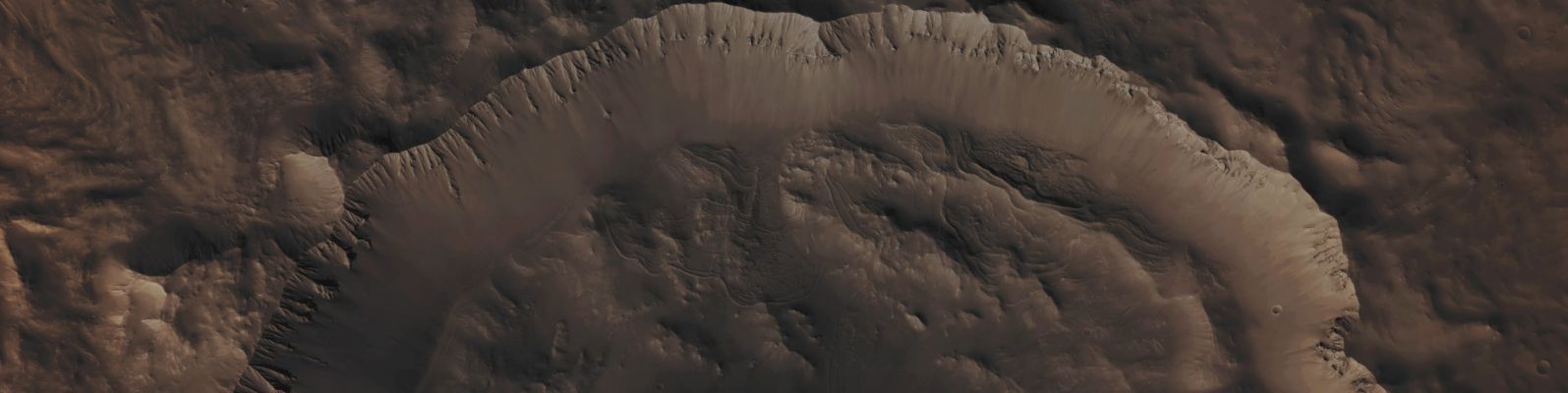 Unnamed Crater with Ridges (Absolute Natural Colors; credits for the additional process. and color.: Dr Paolo C. Fienga/Lunar Explorer Italia/Italian Planetary Foundation)
Mars Local Time: 15:20 (Early Afternoon)
Coord. (centered): 9,515° South Lat. and 16,433° East Long.
Spacecraft altitude: 261,3 Km (such as about 162,267 miles) 
Original image scale range: 52,3 cm/pixel (with 2 x 2 binning) so objects ~ 1 mt and 57 cm across are resolved
Map projected scale: 50 cm/pixel
Map projection: EQUIRECTANGULAR
Emission Angle: 0,7° 
Phase Angle: 60,4°
Solar Incidence Angle: 60° (meaning that the Sun was about 30° above the Local Horizon at the time the picture was taken)
Solar Longitude: 96,6° (Northern Summer - Southern Winter)
Credits: NASA/JPL/University of Arizona
Additional process. and coloring: Lunar Explorer Italia

This picture (which is a NASA - Original Mars Reconnaissance Orbiter NON-Map Projected CTX b/w frame identified by the serial n. ESP_025557_1705) has been additionally processed and then colorized in Absolute Natural Colors (such as the colors that a human eye would actually perceive if someone were onboard the NASA - Mars Reconnaissance Orbiter and then looked down, towards the Surface of Mars), by using an original technique created - and, in time, dramatically improved - by the Lunar Explorer Italia Team.
Parole chiave: Mars from orbit - Craters - Unnamed Crater with Ridges