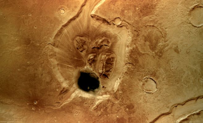 Bird's-Eye view of Mamers Valles (MULTISPECTRUM; credits: Lunexit)
The High-Resolution Stereo Camera (HRSC) onboard the ESA Spacecraft Mars Express obtained images focusing on a depression that displays a crater at the end of the long, winding Valley System known as Mamers Valles. 
The data was obtained on 5 August 2006, with a ground resolution of approx. 14 mt/pixel. The image is centred at approx. 39° North and 17° East on the Planet.

The Mamers Valles System is approx. 1000 Km long, running along the boundary between the Northern Lowlands and Southern Highlands in the Region of Deuteronilus Mensae. 
Scientists term a Region such as Mamers Valles ‘fretted terrain’ because it shows numerous deep and wide labyrinth-like valleys and circular depressions which often show structures formed by flowing liquid on their even floors. The structures formed by the flows are thought to be ice-rich debris flows. They show some resemblance to block glaciers seen on Earth. 
The patches of rock at the centre of the depression are thought to be remnants of rock detached from the flanks of the depression and transported into its centre 
Parole chiave: Mars from orbit - Crater in Mamers Valles System