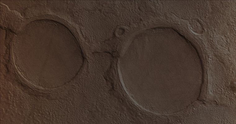 Martian Spectacles! (Absolute Natural Colors; credits for the additional process. and color.: Dr Paolo C. Fienga - Lunexit Team)
Caption NASA originale:"This MGS-MOC image shows a pair of partially-buried impact craters which are being exhumed on a plain east of Hellas in the Promethei Terra Region Mars". 

Location near: 45,5° South; 256,5° West
Image width: ~3 Km (~1,9 mi) 
Illumination from: upper left 
Season: Southern Autumn
Parole chiave: Mars from orbit - Craters - Unnamed Southern Craters