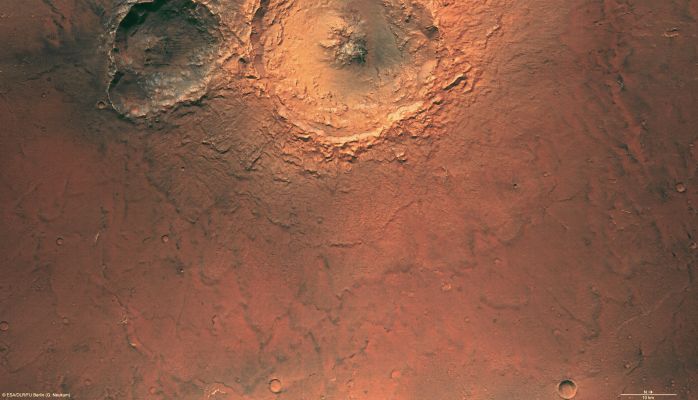 Double Impact Crater in Terra Tyrrhena (Natural Colors + MULTISPECTRUM; credits: ESA & Lunexit)
The High Resolution Stereo Camera (HRSC), ESA’s Mars Express obtained images of the Tyrrhena Terra Impact Region on Mars.
On 10 May 2007, the spacecraft was in orbit number 4294 when it snapped pictures of the Region located at 18° South Lat. and 99° East Long. with a ground resolution of approximately 15 metres per pixel. 
The Western part of the scene is dominated by a 35 Km-wide and approx. 1000 mt-deep impact crater with an extremely cliffy and chiseled edge. Another, 18 Km-long and approx. 750 mt-deep impact crater, in all likelihood a ‘double impact crater’, is located South of the large crater. 
These 'double impact craters' develop when two objects, part of a binary, hit the surface almost simultaneously.
Parole chiave: Mars from orbit - Terra Tyrrhena Region