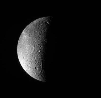 Janiculum Dorsa
Caption NASA:"The Cassini spacecraft looks down, almost directly at the North Pole of Dione. The feature just left of the Terminator at bottom is Janiculum Dorsa, a long, roughly North-South trending ridge. 
Lit terrain seen here is on the anti-Saturn and trailing sides of Dione (1126 Km, or approx. 700 miles across).

This image was taken with the Cassini spacecraft narrow-angle camera on March 22, 2008 using a spectral filter sensitive to wavelengths of ultraviolet light centered at 338 nanometers. The view was acquired at a distance of approx. 650.000 Km (about 404.000 miles) from Dione and at a Sun-Dione-Spacecraft, or phase, angle of 99°. 
Image scale is roughly 4 Km (about 2 miles) per pixel".
Parole chiave: Saturn's Moons - Dione