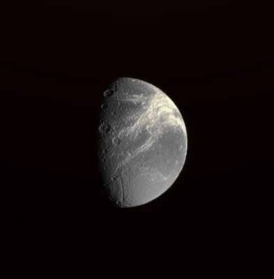 The Bright Canyons of Dione
Caption NASA:"Dione's defining feature, the fractures on its Trailing Side, shine brilliantly in this Cassini Spacecraft view. 
The view was acquired from a position 33° South of the moon's Equator. Lit terrain seen here is on the Trailing Side of Dione (approx. 1123 Km, or about 698 miles across). North is up and rotated 8° to the right. 
The image was taken in visible light with the Cassini spacecraft narrow-angle camera on Sept. 11, 2008. The view was obtained at a distance of approximately 833,000 kilometers (517,000 miles) from Dione and at a Phase Angle of 67°. Image scale is about 5 Km (a little more than 3 miles) per pixel. 

The image was taken with the Cassini Spacecraft wide-angle camera on Aug. 26, 2008 using a spectral filter sensitive to wavelengths of infrared light centered at 752 nanometers. 
The view was acquired at a distance of approx. 397.000 Km (about 246.000 miles) from Saturn. 
Image scale is roughly 20 Km (about 13 miles) per pixel".
Parole chiave: Saturn's Moon - Dione