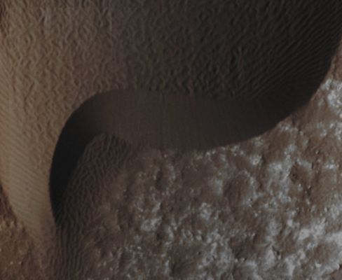 Moving Rippled Dune-Front in Hershel Crater (Enhanced Absolute Natural Colors; credits for the additional process. and color.: Dr Paolo C. Fienga - Lunexit Team)
A Rippled Dune-Front in Herschel Crater on Mars moved about 2 meters (such as about 2 yards) between March 3rd, 2007 and December 1st, 2010. Herschel Crater is located just South of the Equator in the Cratered Highlands. 
This is one of several sites where the orbiter has observed shifting Sand Dunes and Ripples. Previously, scientists thought sand on Mars was mostly immobile. It took the mission's High Resolution Imaging Science Experiment (HiRISE) to take sharp enough images to finally see the movement. While Dust is easily blown around the Red Planet, its thin Atmosphere means that strong Winds are required to move Grains of Sand.
Parole chiave: Mars from orbit - Dunefield - Herschel Crater