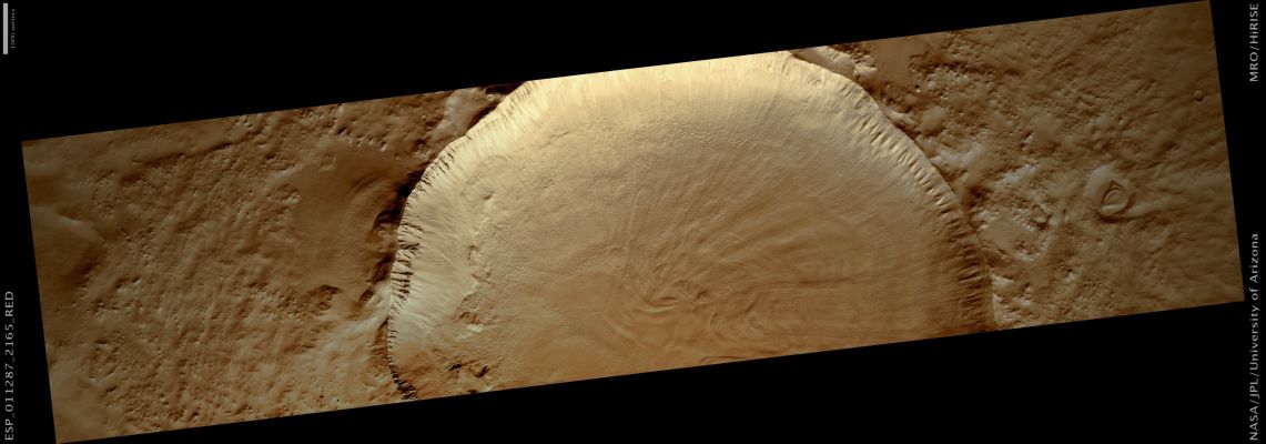 Fresh Impact Crater in Utopia Planitia (Natural Colors; credits: Lunar Explorer Italia)
This fresh Unnamed Crater is located in the Northern Mid-Latitudes. It is designated as fresh because of its very sharp rim.
The Crater has experienced some modification since it formed, including a few tiny craters on the South Wall.
The rough texture of the floor is suggestive of ground ice, which is expected to exist in the Mid-Latitudes. Ground ice aids gravity in moving material from the Crater Walls towards the center. Material is visible slumping off the North-Western Crater Wall in this fashion. The wavy texture of the center of the Crater floor suggests that material has been transported from the walls and merged in the center. 


Mars Local Time: 15:42 (middle afternoon)
Coord. (centered): 36,0° North Lat. and 80,5° East Long.
Spacecraft altitude: 292,7 Km (such as about 182,9 miles) 
Original image scale range: 58,6 cm/pixel (with 1 x 1 binning) so objects ~1,76 mt across are resolved 
Map projected scale: 50 cm/pixel
Map projection: EQUIRECTANGULAR 
Emission Angle: 2,9° 
Phase Angle: 59,7°
Solar Incidence Angle: 62° (meaning that the Sun is about 28° above the Local Horizon)
Solar Longitude: 178,5° (Northern Summer)
Credits: NASA/JPL/University of Arizona
Additional process. and coloring: Lunar Explorer Italia
Parole chiave: Mars from orbit - Craters - Unnamed Crater in Utopia Planitia