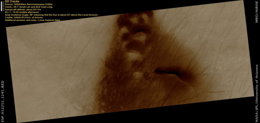 Dust Devils Tracks (Natural Colors; credits: Lunar Explorer Italia)
This image is located in a crater in the Hellespontus region that displays dunes and dust devil tracks.

The larger barchan-like dunes are surrounded by linear ripples and dark coarse material. The dunes are composed of basaltic sands that have accumulated in the troughs of the dunes. The dunes themselves run in a northeast to southwest direction. The steep west facing slip face indicates that the dune is controlled by a southeasterly direction and that the winds here tend to blow from left to right.

Both the sandy and rough textured surfaces are crisscrossed by the tracks of dust devils. These tracks form when dust devils abrade the surface exposing the underlying darker surface. The tracks appear to be clustered since dust devils frequently form in areas that have been previously scoured. The lighter tracks are older tracks that are fading or have been overprinted by other dust devils. 

It is possible that the dunes are stable as many of the dust devils appear to be going to the southeast direction (based on scallop patterns- dust devil leaves behind dark circular patterns and erase the frost as it moves forward by local winds). This is an indication of change of wind especially since the dune field is in a crater.

Parole chiave: Mars from orbit - DD Tracks - Hellespontus Region