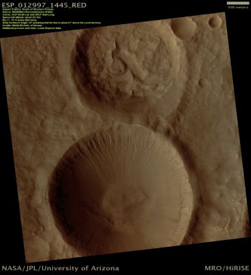 "8"! (Natural Colors; credits: Lunar Explorer Italia)
This image shows two craters in the Southern Hemisphere just South of Sirenum Fossae.
The Northern Crater (the one that is an upper position) is smaller, appears more degraded, and is partially filled with sediments that form a hummocky surface. Dunes have formed subsequently on this Surface. Some incipient gully-like features have formed midway along the Southern Crater Wall and expose Layers that are more resistant to erosion.
The larger crater to the South is eroded by Gullies on its Northern Slope while the Southern Slope Region lacks them. Most Gullies in this scene appear to emanate from more resistant Layers, although the larger Gullies have eroded back almost to the Crater Rim. 

The nature of the Layers and their connection to the water that formed the Gullies is unknown. 
Gullies typically form when flowing water erodes sediments and soft rocks in a channelized flow. Because Mars is very cold and dry, it is unknown where the water came from to form the Gullies.
Parole chiave: Mars from orbit - Craters - Unnamed Craters