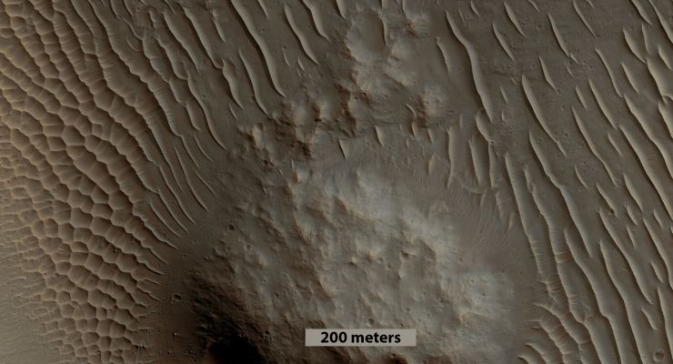 Unnamed Southern Crater with Gullies, Rolling Boulders and Dunes (EDM n. 2 - Absolute Natural Colors; credits for the additional process. and color.: Dr Paolo C. Fienga - Lunexit Team)
Caption NASA:"This image shows a nice example of different types of Dunes in close proximity to each other: North is at roughly 03:00 in this EDM. 

On either side of the Mound - which is located on the Southern End of the Crater Floor - there are different types of Dunes. On the Southern side of the mound (left side of the EDM), there are "Star Dunes" (named for the Star-like Intersections of their Crests). These types of Dunes are usually formed when the wind blows in multiple directions.
On the Northern side of the Mound (the right when looking at the EDM), there are simpler Dune shapes, forming roughly straight, parallel lines. Notice that the same side of each Dune is steeper. These are called Linear Dunes, and are formed by wind blowing mainly parallel to the direction of their Crests, probably with some variation to one side or the other that causes the asymmetrical Slopes. The Linear Dunes transition to the Star Dunes near the Mound. 

Since the main factor controlling which type of Dunes are formed is the (Dominant) Winds' Direction, there must have been different Wind Directions in this area (for instance, it is very likely that significant whirlpools were caused by the wind blowing around the Mound or also when they interacted with the nearby Crater Wall).
Parole chiave: Mars from orbit - Craters - Unnamed Crater with Gullies and Rolling Boulders
