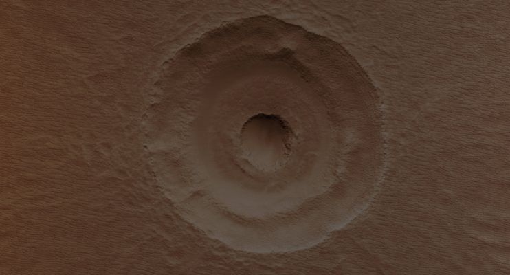 Bull's Eye Impact Crater (Absolute Natural Colors; credits for the additional process. and color.: Dr Paolo C. Fienga - Lunexit Team)
What caused the Central Pit within this Impact Crater: unusual Subsurface Layering or a lucky second impact? Impacts into layers of alternately strong and weak material – for example, ice rich versus non-ice-rich – produce terracing such as that seen between the Inner Pit and the Outer Rim. Scientists have used Terraced Craters to estimate the thickness of Lava Flows on the Moon and elsewhere. Uneven Sublimation and Periglacial Erosion of exposed ice-rich material in the interior of the Crater may explain why the small Central Pit is slightly offset from center relative to the Terrace and Rim of the larger Crater. 
The Pit in the center of the main feature could also be from a later Impact Crater striking inside and slightly off-center from the original. It has a Raised Rim, which is characteristic of impact craters and is difficult to explain with a layered target. While no ejecta from this later impact can be seen, the ejecta could have been removed by extensive periglacial modification. 
Additionally the Floor Fill around the Inner Crater resembles impact ejects elsewhere at this latitude, and some of the "Landslides" to the East could be flow-back of ejecta off the Walls of the larger crater.
Parole chiave: Mars from orbit - Craters - Unnamed Crater with "Bull's Eye" shape