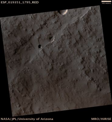 Collapse Pit on the S/E Flank of Pavonis Mons (CTX Frame - Absolute Natural Colors; credits for the additional process. and color: Dr Paolo C. Fienga - Lunexit Team)
Caption NASA:"This image is located on the South/Eastern Flank of Pavonis Mons, a large Volcano located in the Tharsis Region of Mars. The dark, circular Pit Feature roughly in the middle of the image is about 180 meters at its widest diameter. The Pit appears to be surrounded by small sand dunes". 

Acquisition date: 12 September 2010 
Mars Local Time: 15:33 (Middle Afternoon)
Latitude (centered): 0,5° South 
Longitude (East): 248,6° 
Spacecraft Altitude (such as "Range to Target Site"): 256,4 Km (160,2 miles) 
Original Image Scale Range: 25,6 cm/pixel (with 1 x 1 binning) so objects ~77 cm across are resolved 
Map Projected Scale: 25 cm/pixel and North is up 
Map Projection: EQUIRECTANGULAR 
Emission Angle: 3,2° 
Sun-Target-MRO (such as "Phase") Angle: 51,8°
Solar Incidence Angle (S.I.A.): 55°, with the Sun about 35° above the Local Horizon 
Solar Longitude: 147,2° (Northern Summer)
Parole chiave: Mars from orbit - Volcanic Features - Skylight