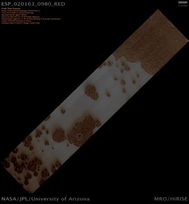 South Polar Features (Absolute Natural Colors; credits: Dr Paolo C. Fienga - Lunexit Team)
HiRISE images are monochromatic across much of the scene, but in the center we return color data. The color strip down the center of this image gives us insight into Aerosols (such as particles of Dust and Frost) suspended in the Atmosphere and the seasonal processes that get them there. In the Winter Mars' South Polar Region is covered by a layer of CO2 ice (dry ice). 

In the Spring this ice evaporates from the top and the bottom of the Seasonal Ice Layer (typically a few centimeters thick). Where there are cracks in the ice, the gas from below escapes, carrying fine particles from the Surface up to the top of the ice. Larger particles fall back onto the ground in Fan-shaped Deposits pointing in a direction determined by the local winds. We see the smaller particles (Dust) suspended in the air locally over the cracks as the bluish tone over the Regions with Fans. 

Over Regions without Fans, where Gas and Dust from the Surface are not escaping into the Atmosphere, the Surface is a more pinkish tone.
Parole chiave: Mars from orbit - South Polar Features