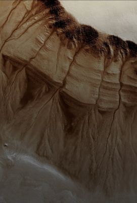 South Polar "Pit Gullies" (EDM - Absolute Natural Colors; credits for the additional process. and color.: Dr Paolo C. Fienga - Lunexit Team)
Numerous Gullies that have formed along the S/W Wall of an elongated shaped Pit are visible in this image. This Pit is located within a degraded approx. 100 Km Impact Crater located in the Southern Presso-Polar Regions of Mars. 

Gullies originate along the rubbly, bouldery upper Wall Region and have eroded into the numerous Layered Wall Units before terminating in Fan Deposits on the Pit Floor (here, in the EDM). A previous HiRISE image (ESP_020956_1115) of this location taken during the Spring, showed Frost and interesting dark-toned Flows within the Gully Channels. Neither Frost nor Dark Flows are apparent in this Summer-time image. One goal of HiRISE is to repeat observations at locations such as this to detect changes that may lead to understanding how these Gullies form.
Parole chiave: Mars from orbit - South Polar Features - Pit Gullies