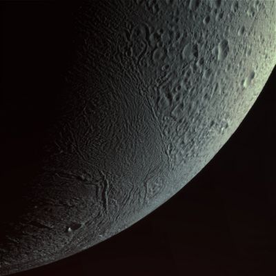 Over and Above... (natural colors; credits: Lunexit)
Caption NASA:"What does the surface of Saturn's ice-spewing moon Enceladus look like? To help find out, the robotic Cassini Spacecraft now orbiting Saturn was sent soaring past the cryovolcanic moon and even right through one of Enceladus' ice plumes. 
Cassini closed to about 52 Km during its closest encounter to date. The above unprocessed image was taken looking down from the North, from about 30.000 Km away. Visible are at least two types of terrain. 
The first type of terrain has more craters than occur near Enceladus' South Pole. 
The other type of terrain has few craters but many ridges and grooves that may have been created by surface-shifting tectonic activity. 

Exogeologists are currently poring over this and other Cassini images from last Wednesday's flyby to better understand the moon's patch-work surface, its unusual ice-geysers, and its potential to support life. Cassini is scheduled to fly by Enceladus at least 9 more times, including an even closer pass of just 25 Km in October 2008".
Parole chiave: Saturn's Moons - Enceladus