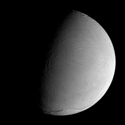 The Leading Hemisphere of Enceladus
Caption NASA:"During a distant flyby encounter with Enceladus, Cassini imaged the moon's wrinkled Leading Hemisphere. 
At the scale visible here, this region of the surface is generally devoid of impact craters, suggesting that the terrain has been modified and renewed during the moon's history. 
To the North lies a heavily cratered and presumably older Region. The sinuous boundary of the geologically active South Polar Region is seen at bottom. North on Enceladus is toward the top of the image. 

The image was taken in visible green light with the Cassini Spacecraft narrow-angle camera on Sept. 30, 2007. The view was acquired at a distance of approx. 108.000 Km (such as about 67.000 miles) from Enceladus and at a Sun-Enceladus-Spacecraft, or phase, angle of 75°. 
Image scale is 644 meters (2111 feet) per pixel".
Parole chiave: Saturn's Moon - Enceladus