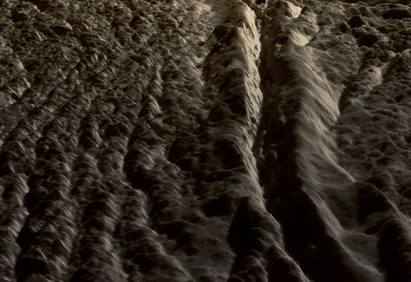 Perspective view of Damascus Sulcus, Enceladus (Natural Colors; credits: Lunexit)
This perspective view of Damascus Sulcus was generated using high resolution images of Enceladus acquired in August 2008 at 12 to 30 meters (40 to 100 feet) resolution, together with a new topographic map of the region produced by Dr. Paul Schenk (http://www.lpi.usra.edu/lpi/schenk/) at the Lunar and Planetary Institute in Houston, TX. 

Damascus Sulcus is one of several prominent linear structures, dubbed “Tiger Stripes”, within the geologically active South Polar Region of Enceladus. Damascus Sulcus consists of two large parallel ridges separated by a deep V-shaped medial trough. The ridges are each 100 to 150 meters high (325 to 500 feet), while the entire width of Damascus Sulcus is approx. 5 Km (a little more than 3 miles). The medial trough between the ridges is 200 to 250 meters (650 to 820 feet) deep, and may have formed by daily shear (sliding) faulting triggered by tidal forces. 
These medial troughs may be the primary source of numerous jets making up the large active water vapor plume over the South Pole of Enceladus. Several small ridges can be seen along the floor of the medial trough. These could be blocks of crust that have slid down the walls of the trough or fractured blocks pushed up from below. 

Flanking Damascus Sulcus are repeating sets of broken and disrupted parallel ridges a few tens of meters high. These are typical of the plains that lie between the tiger stripe structures and resemble crumpled or folded rock patterns seen on Earth. Relief has been exaggerated by a factor of ~10 to enhance clarity. 

The raw data from which this product was developed were retrieved from the Planetary Data System's Cassini archives. The Cassini-Huygens mission is a cooperative project of NASA, the European Space Agency and the Italian Space Agency. The Jet Propulsion Laboratory, a division of the California Institute of Technology in Pasadena, manages the mission for NASA's Science Mission Directorate, Washington, D.C. The Cassini orbiter and its two onboard cameras were designed, developed and assembled at JPL. The imaging operations center is based at the Space Science Institute in Boulder, Colo. (http://ciclops.org)
Parole chiave: Saturn's Moon - Enceladus