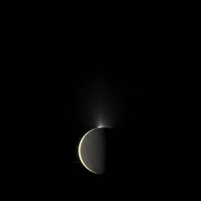 The "Fountains" of Enceladus at "High Phase" (Absolute Natural Colors; credits for the additional process. and color.: Dr Paolo C. Fienga - Lunexit Team)
Caption NASA:"Saturn's moon Enceladus, imaged at High Phase, shows off its spectacular Water Ice Plumes emanating from its South Polar Region.
This image was captured at a Phase, or Sun-Enceladus-Spacecraft, Angle of 159° so that Sunlight would reveal the backlit plumes.
Sunlight brightly illuminates Terrain on the left. Light reflected off Saturn illuminates the rest of the moon more dimly. This view looks toward the Trailing Hemisphere of Enceladus. North is down. Background stars, elongated by the movement of the Spacecraft during the exposure, are also visible.

The image was taken in Visible Light with the Cassini Spacecraft narrow-angle camera on Oct. 13, 2009. The view was obtained at a distance of approx. 431.000 Km (about 268.000 miles) from Enceladus. 
Image scale is roughly 3 Km (about 1,9 miles) per pixel".
Parole chiave: Saturnian Moons - Enceladus