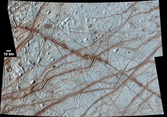Rhadamanthys Linea (Enhanced Natural Color Version)
Caption NASA Originale:"Europa's Surface is covered with a vast network of Linear Features such as cracks, ridges, and bands, as well as other smaller circular features that include pits, spots, domes, and microchaos. 
This image, created from clear-filter images taken on the Galileo spacecraft's 17th orbit around Jupiter and colorized with lower-resolution images taken on Galileo's first orbit around Jupiter, shows a huge variety of these feature types. 
Of particular note is the prominent ridge at the center of the image, called Rhadamanthys Linea. 
While most ridges have a reddish appearance in colorized images such as this enhanced color version, Rhadamanthys appears to have uneven blotches of darker, redder material which are more prominent in some locations than in others. 
Some scientists have interpreted the appearance of Rhadamanthys to indicate that it is a recently, or perhaps currently, active feature on Europa's Surface".
Parole chiave: Jupiter's Moons - Europa