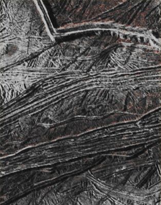 Features of Europa (Absolute Natural Colors; credits for the additional process. and color.: Dr Paolo C. Fienga/Lunar Explorer Italia/Italian Planetary Foundation)
This image, taken by the NASA - Galileo Spacecraft on February, 2, 1999, shows us huge Cracks and Ridges on the Surface of the Jovian moon Europa. These (absolutely fascinating) Features reveal a complex Geologic History of Europa. Some Ridges, such as the prominent one, at the top right of the frame, develop into several long, arc-shaped "Cycloids" (---> a Cycloid is the curve traced by a point on the rim of a circular wheel as the wheel rolls along a straight line), that could reasonably be related to the changing Tidal Forces as Europa orbits the Gas-Giant Planet Jupiter. The Wall of this Ridge stands perhaps a third of a mile (approx. 0,5 Km) above the surrounding Ridged Plains, although their Edges are - likely - NOT as steep as they appear in this view.

The view was captured by the NASA - Galileo Spacecraft on February 2, 1999, during its E19 orbit, when the spacecraft was about 2500 miles (such as approx. 4023 km) from the Surface of Europa. The Resolution in the scene is roughly 295 feet (such as approx. 89.91 meters) per pixel. North is toward bottom left side of the picture.

This frame (which is a crop taken from an Original NASA - Galileo Spacecraft enhanced color image published on the NASA - Planetary Photojournal with the ID n. PIA 17737) has been additionally processed, contrast enhanced, magnified to aid visibility of the Surface details and then re-colorized, according to an educated guess carried out by Dr Paolo C. Fienga/LXTT/IPF, in what they should be its Absolute Natural Colors (such as the colors that a human eye would actually perceive if someone were onboard the NASA - Galileo Spacecraft and then looked outside, towards the Surface of the Jovian moon Europa), by using an original technique created - and, in time, dramatically improved - by the Lunar Explorer Italia Team. Different colors, as well as different shades of the same color, mean, among others, the existence of different Elements present on the Surface of Europa, each having a different Albedo (---> Reflectivity) and Chemical Composition.

Note: it is possible (but we, as IPF, have no way to be one-hundred-percent sure of such a circumstance), that the actual luminosity of Europa- as it is in this frame - would appear, to an average human eye, a little bit lower than it has been shown (or, better yet: interpreted) here.
Parole chiave: Jovian Moons - Europa