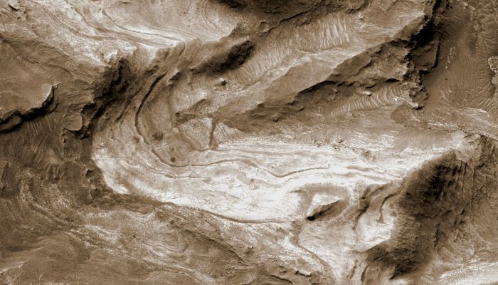Layers in lower formation of Gale Crater Mound (Natural Colors; credits NASA/Dr Paolo C. Fienga - Lunexit Team)
Layers of rock exposed in the lower portion of a tall Mound near the center of Gale Crater on Mars exhibit variations in layer thickness and range between dark and light tones. The Crater's Mound of layered material is over 4 Km (approx. 2,4 miles) high, making it more than twice as thick as the stack of rocks exposed in the Grand Canyon on Earth. 
Gale Crater is approx. 152 Km (about 94 miles) in diameter.
This view of layering in the Mound's lower formation covers an area about 950 meters (3100 feet) wide. It was taken by the High Resolution Imaging Science Experiment (HiRISE) camera on NASA's Mars Reconnaissance Orbiter on April 23, 2009. 
Observations of the lower formation by the Compact Reconnaissance Imaging Spectrometer for Mars, on the same orbiter, have indicated the presence of Sulfate Salts and clay minerals in these rock layers. The changes in composition from the lower (older) to the upper (younger) layers in the Gale Crater Mound may record stages in water loss and the drying out of Mars.

This image is one product from HiRISE observation ESP_012841_1750, centered at 4,9° South Lat., 137,2° East Long.
Parole chiave: Mars from orbit - Craters - Gale Crater