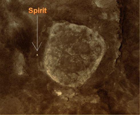 Spirit at Home Plate
In this view from orbit, the pale circular shape in the center is a low plateau called "Home Plate", about 80 meters (about 260 feet) across. The bright dot just to the left of Home Plate at the 9 o'clock position is NASA's MER Spirit. North is toward the top. 

The view is a portion of an image taken on June 13, 2009, by the High Resolution Imaging Science Experiment (HiRISE) camera on NASA's Mars Reconnaissance Orbiter. At that date, Spirit had been embedded for more than a month in a patch of soft soil called "Troy". 
During the subsequent 3 months, Spirit studied the unusually layered soil at the site while engineers used test rovers at NASA's Jet Propulsion Laboratory to assess possible maneuvers for getting Spirit away from Troy. 
The site is at 14,6° South Latitude and 175,5° East Longitude. Home Plate is in the inner basin of the Columbia Hills range, inside Mars' Gusev Crater. Spirit has been exploring the Columbia Hills and nearby features since January 2004.
Parole chiave: Mars from orbit - Craters - Gusev Crater
