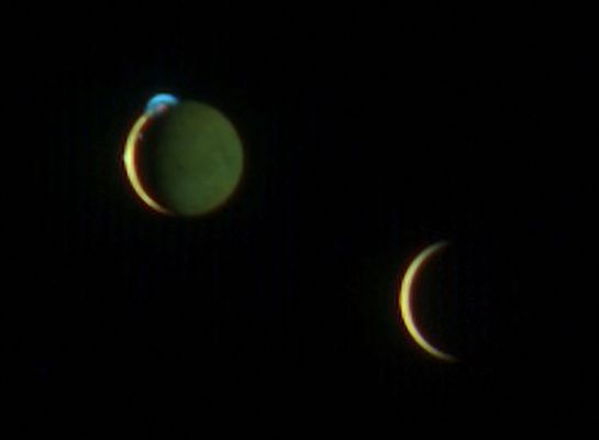 Io and Europa, from New Horizons
This beautiful image of the crescents of volcanic Io and more sedate Europa was snapped by New Horizons' color Multispectral Visual Imaging Camera (MVIC) at 10:34 UT on March 2, 2007, about two days after New Horizons made its closest approach to Jupiter. 
The picture was one of a handful of the Jupiter System that New Horizons took primarily for their artistic, rather than scientific value. This particular scene was suggested by space enthusiast Richard Hendricks of Austin, Texas, in response to an Internet request by New Horizons scientists for evocative, artistic imaging opportunities at Jupiter.

This image was taken from a range of 4,6 MKM (about 2,8 MMs) from Io and 3,8 MKM (about 2,4 MMs) from Europa. Although the moons appear close in this view, a gulf of 790.000 Km (490.000 miles) separates them. The night side of Io is illuminated here by light reflected from Jupiter, which is out of the frame to the right. Europa's night side is completely dark, in contrast to Io, because that side of Europa faces away from Jupiter. 


Here, Io steals the show with its beautiful display of volcanic activity. Three volcanic plumes are visible. Most conspicuous is the enormous 300-Km(190-mile) -high plume from the Tvashtar volcano at the 11 o'clock position on Io's disk. Two much smaller plumes are barely visible: one from the volcano Prometheus, at the 9 o'clock position on the edge of Io's disk, and one from the volcano Amirani, seen between Prometheus and Tvashtar along Io's Terminator (the line dividing day and night). The plumes appear blue because of the scattering of light by tiny dust particles ejected by the volcanoes, similar to the blue appearance of smoke. In addition, the contrasting red glow of hot lava can be seen at the source of the Tvashtar plume.

The images are centered at 1° North, 60° West on Io, and 0° North and 149° West on Europa. 
The color in this image was generated using individual MVIC images at wavelengths of 480, 620 and 850 nanometers. The human eye is sensitive to slightly shorter wavelengths, from 400 to 700 nanometers, and thus would see the scene slightly differently. For instance, while the eye would notice the difference between the yellow and reddish brown colors of Io's surface and the paler color of Europa, the two worlds appear very similar in color to MVIC's longer-wavelength vision. 
The night side of Io appears greenish compared to the day side, because methane in Jupiter's atmosphere absorbs 850-nanometer light and makes Jupiter-light green to MVIC's "eyes."

MVIC is a component of the Ralph imaging instrument. 
Parole chiave: Jupiter's Moons - Io and Europa