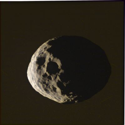 Janus (RAW Natural Colors; credits for the additional process. and color.: Elisabetta Bonora and Marco Faccin - Lunexit Team)
Janus - apparently, and according to our Readers, one of the most interesting Celestial Bodies that we have shown and talked about on our APOD in the past - is one of the so-called "Inner Natural Satellites" of the Giant Gas-Planet Saturn; it is also called and known, sometimes, as Saturn X, and it occupies (better yet: shares) the same orbit as the Saturnian Inner Minor moon Epimetheus. This (now we know NOT infrequent) circumstance, however caused, in the past, some confusion to many astronomers which, at the time of Janus' discovery - and according to their different observations - assumed that there should have been only one Celestial Body in the orbit where Janus was spotted. 
For a long time, in fact, the Astronomical Community struggled to figure out what was going on, until they realized that what they were trying to solve, was (let us use this expression) an "impossible equation": in other words, they were trying to reconcile (so-called "reductio ad unum")  different observations of different and distinct Objects, on the wrong assumption that what they all were looking at, was just a single Celestial Body.
The discovery of Janus is attributed to its first observer, such as the French Astronomer Audouin Dollfus, who spotted Janus on December 15, 1966. The newly discovered Object was given the temporary designation of "S/1966 S 2". Previously, though, another Astronomer (Jean Texereau) had also photographed the very same Celestial Body (to be exact, on October 29, 1966), but without realizing the discovery! On December 18 of the same year, then, Richard Walker made a similar observation which is now credited as the discovery of Epimetheus.

Twelve years later, in October 1978, Stephen M. Larson and John W. Fountain finally realized that the 1966 observations would have been better explained by assuming that they were relative NOT to one, BUT to two distinct Objects (as we said, Janus and Epimetheus), sharing very similar (or perhaps the same, as we know now) orbits. Finally, in the AD 1980, the NASA - Voyager 1 Spacecraft confirmed that this "controversial moon" was, in fact, a couple of co-orbital Celestial Bodies. 
Afterwards, Janus was observed on other occasions and given different provisional designations. It was observed, for instance, by the NASA - Pioneer 11 Probe when it passed near Saturn on September 1st, 1979. Janus was also observed by Dan Pascu on February 19, 1980 (and then provisionally designed as "S/1980 S 1") and then by John W. Fountain (once again), Stephen M. Larson (again), Harold J. Reitsema and Bradford A. Smith on the 23rd (and, this time, the observed object was, always provisionally, recorded as "S/1980 S 2"). 
All these Scientists, in a way and in the end, should therefore share, to various degrees, the title of Discoverer of Janus, but this "fair dispute", so far (and as far as we know), has not been solved. 

As far as the physical characteristics of Janus are concerned, we can say that this relatively small moon (whose dimensions are approx. 203 × 185 × 153 Km) is extensively cratered, and a few of these craters are more than 30 Km across. The Janian Surface, as we already wrote in the past, appears to be older than Prometheus' one, but younger than Pandora's. Furthermore, if you consideri its oval (or, if you prefer, its "non-spherical") shape, its (very) low Density and relatively high Albedo, it seems logic to conclude, for the time being, that Janus should just be a porous and icy "rubble pile" (such as the final result of a cloud of Cosmic Debris that have coalesced under the influence of gravity). 

The so-called Rubble Piles-type Celestial Bodies have a low density because there are, we believe, large cavities between the various "chunks" - such as fragments - of rocky material that made them up; Rubble Piles may also form when an Asteroid or a moon (which may originally be monolithic - such as "one single piece of rock") is smashed by an impact, and the shattered pieces left over by the impact, in time, fall back together, primarily due to self-gravitation (---> mutual attraction). In other words: a Celestial Body like Janus is formed, in our opinion, by a mass of different materials that cohered over time (we repeat: something like a "cloud" of Cosmic Debris - rocks, boulders, dust etc. - which, in time, due to a mutual gravitational attraction, got together until they became one - yet extremely fragile - Celestial Body). 
In the light of the above considerations and assumptions, we, as IPF, believe that Janus can reasonably be assimilated, for instance (and among others), to Asteroid 25143 Itokawa or 433 Eros.
Parole chiave: Saturnian Moons - Janus