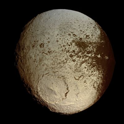 Japetus (Natural Colors; credits: Lunexit)
Da "NASA - Picture of the Day", del giorno 9 Agosto 2009:"What has happened to Saturn's moon Japetus? Vast sections of this strange world are dark as coal, while others are as bright as ice. The composition of the dark material is unknown, but InfraRed Spectra indicate that it possibly contains some dark form of carbon. 
Japetus also has an unusual equatorial ridge that makes it appear like a walnut. To help better understand this seemingly painted moon, NASA directed the robotic Cassini Spacecraft orbiting Saturn to swoop within 2000 Km in 2007. 
Pictured above, from about 75.000 Km out, Cassini's trajectory allowed unprecedented imaging of the hemisphere of Japetus that is always trailing. 
A huge impact crater seen in the South spans a tremendous 450 Km and appears superposed on an older crater of similar size. The dark material is seen increasingly coating the easternmost part of Japetus, darkening craters and highlands alike. 

Close inspection indicates that the dark coating typically faces the moon's Equator and is less than a meter thick. A leading hypothesis is that the dark material is mostly dirt leftover when relatively warm but dirty ice sublimates. An initial coating of dark material may have been effectively painted on by the accretion of meteor-liberated debris from other moons. 
This and other images from Cassini's Japetus flyby are being studied for even greater clues".
Parole chiave: Saturn's Moon - Japetus