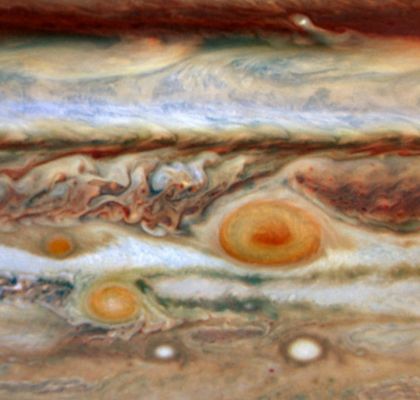 The "Eyes" of Jupiter
For about 300 years Jupiter's "Banded" Atmosphere has shown a remarkable feature to telescopic viewers, a large swirling storm system known as "The Great Red Spot". In 2006, another red storm system appeared, actually seen to form as smaller whitish oval-shaped storms merged and then developed the curious reddish hue. Now, Jupiter has a third red spot, again produced from a smaller whitish storm. All three are seen in this image made from data recorded on May 9 and 10 with the Hubble Space Telescope's Wide Field and Planetary Camera 2. The spots extend above the surrounding clouds and their red color may be due to deeper material dredged up by the storms and exposed to ultraviolet light, but the exact chemical process is still unknown. For scale, the Great Red Spot has almost twice the diameter of planet Earth, making both new spots less than one Earth-diameter across. The newest red spot is on the far left (West), along the same band of clouds as the Great Red Spot and is drifting toward it. If the motion continues, the new spot will encounter the much larger storm system in August. Jupiter's recent outbreak of red spots is likely related to large scale climate change as the gas Giant Planet is getting warmer near the Equator.
Parole chiave: Jupiter