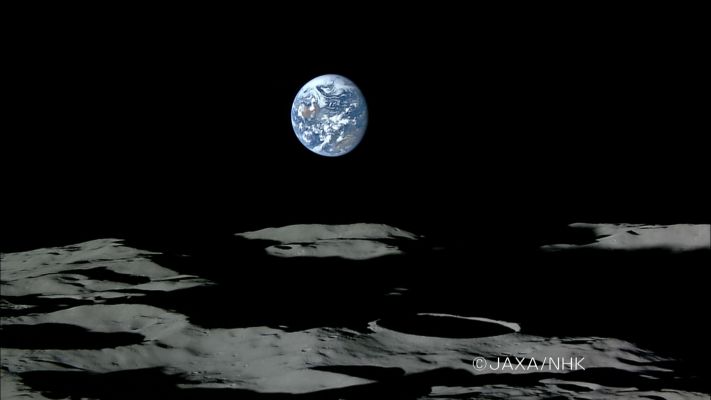 The setting "Blue Marble", from Lunar Orbit (Kaguya is near the Lunar South Pole)
Caption JAXA:"This still image was cut out from a moving image (tele shot) taken by the HDTV onboard the KAGUYA at 12:07 p.m. on November 7, 2007 (Japan Standard Time, JST,) then sent to the JAXA Usuda Deep Space Center.
In the image, the Moon's surface is near the South Pole, and we can see the Australian Continent (center left) and the Asian Continent (lower right) on the Earth. 
(In this image, the upper side of the Earth is the Southern Hemisphere, thus the Australian Continent looks upside-down)".
Parole chiave: Postacard from Space
