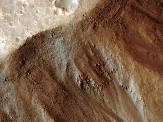 Features of Kasei Valles (EDM - Saturated Natural Colors; credits for the additional process. and color.: Dr Paolo C. Fienga - Lunexit Team)
This observation from NASA's Mars Reconnaissance Orbiter (MRO) shows the very steep side of a Plateau, part of the Northern Limit of the Kasei Valles System, which is one of the largest Outflow Channel Systems on Mars. The difference in elevation here between the mostly flat Channel's Floor (bottom right) and the top of the Plateau (top left) is over 1300 meters (about 0,8 miles), comparable in height to the Grand Canyon Walls. The Kasei Valles System is much wider than the Grand Canyon, though, getting to be in places approx. 500 Km (such as about 300 miles) wide. (The Grand Canyon's maximum width is approx. 30 Km, or about 18 miles).

This EDM shows numerous paths with the appearance of dotted lines, criss-crossing the steep side of the Plateau. The carving agents can be found at the end of some of these paths: rocky blocks such as the ones in this subset, up to 2 meters (2,2 yards) across (4 meters or 4,4 yards across elsewhere in the image). Some of these blocks traveled downhill several hundred meters (yards) as they rolled and bounced leaving behind a trail of indentations or poke marks in the surface's fine-grained, light-toned soils. The raised borders in some of these poke marks indicate they are relatively recent features, unaffected by wind erosion, or that this soil has cohesive properties, such as if it was cemented.

The sound of these blocks falling did not travel very far, though. According to computer simulations sound in Mars travels only 1,5% (per-cent) the distance it would travel on Earth. (No Martian sound has ever been officially recorded) Hence, the same sound which would travel one Km (0,6 miles) on Earth, would travel only 15 meters (16 yards) on Mars. This is due to the lower Martian Atmospheric Pressure, which is approximately 1% of that of the Earth.
Parole chiave: Mars from orbit - Kasei Valles