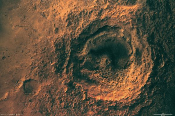 Maunder Crater (Natural Colors + MULTISPECTRUM; credits: ESA & Lunexit)
The above image shows the striking Maunder crater lying at approx. 50° South Lat. and 2° East Long., in the Noachis Terra Region on Mars. 
The High Resolution Stereo Camera (HRSC) on ESA’s Mars Express orbiter took pictures of the Noachis Terra Region during orbits 2412 and 2467 on 29 November and 14 December 2005, respectively, with a ground resolution of approx. 15 mt/pixel. 
The Sun illuminates the scene from the North-East (top left in the image). 

Maunder crater, named after the British Astronomer Edward W. Maunder, is located halfway between Argyre Planitia and Hellas Planitia on the Southern Highlands of Mars. 
With a diameter of 90 Km and a depth of barely 900 mt, the Crater is not one of the largest impact craters on Mars at present, but it used to be much deeper. It has since been filled partially with large amounts of material.
Parole chiave: Mars from orbit - Craters - Maunder Crater
