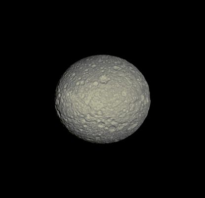 "Oblate" Mimas (Possible Natural Colors; credits: Lunexit)
Caption NASA:"The Cassini Spacecraft reveals the cratered surface of Mimas, a moon whose shape is flattened at the Poles. (see PIA07534 to learn more about why the moon has this oblate shape) 
This view looks toward the Trailing Hemisphere of Mimas (approx. 396 Km, or about 246 miles, across). North on Mimas is up and rotated 1° to the left. 

The image was taken in Visible Green Light with the Cassini Spacecraft narrow-angle camera on Oct. 14, 2009. The view was acquired at a distance of approx. 273.000 Km (such as about 170.000 miles) from Mimas and at a Sun-Mimas-Spacecraft, or Phase, Angle of 5°. 
Image scale is roughly 2 Km (about 1,4 miles) per pixel".
Parole chiave: Saturn's Moon - Mimas