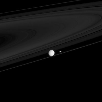The "Ring-Masters" of Saturn
Caption NASA:"Two moons that have profound impacts on the Rings of Saturn, Mimas and Prometheus, are seen here with the F-Ring. 

Mimas (approx, 396 Km, or about 246 miles across), the larger and much more distant of the moons, creates the Cassini Division: between the A and B-Rings. 
Prometheus (approx. 86 Km, or about 53 miles across), although much smaller than Mimas, is half of a duo responsible for maintaining the narrow FRing".
Parole chiave: Saturn's Moon - Mimas and Prometheus