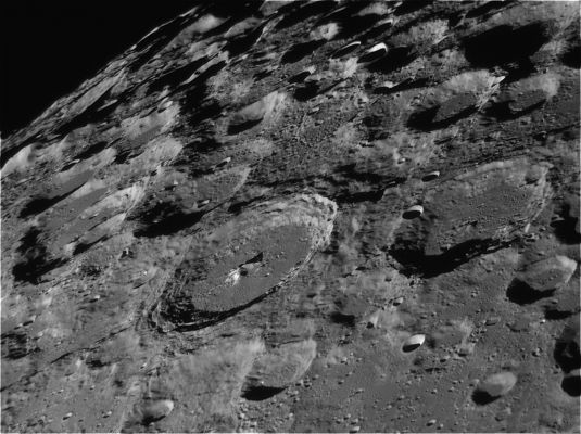 The Southern Highlands of the Moon (Moretus and Curtius)
Caption NASA:"The Moon's South Pole is near the top of this sharp telescopic view looking across the Southern Lunar Highlands. Recorded on August 3rd, 2007, from Tecumseh, Oklahoma, planet Earth, the foreshortened perspective heightens the impression of a dense field of craters and makes the craters themselves appear more oval shaped. The prominent crater in the foreground, Moretus, has a diameter of 114 Km and lies just west (left) of the Moon's Central Meridian. For large lunar craters, Moretus is young and features terraced inner walls and a 2,1 Km high, bright central peak, similar in appearance to the more northerly crater Tycho. Just to the right of Moretus is the 95 Km diameter crater Curtius. 
Curtius has older, rounded walls marked by smaller, more recent impact craters".
Parole chiave: The Moon from Earth