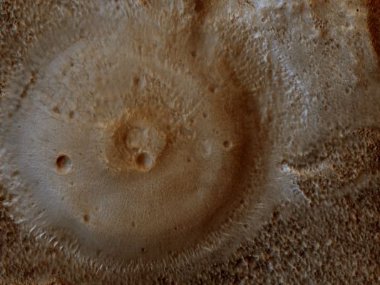 Mud Volcanoes on Mars? (Natural Colors; credits: Lunar Explorer Italia)
Da "NASA - Picture of the Day" del giorno 30 Marzo 2009:"Is this a Mud Volcano on Mars? If so, could it be dredging up Martian Microbes? This strange possibility has been suggested recently and seems to fit several recent observations of Mars. 
First of all, hills like this seem to better resemble Mud Volcanoes on Earth than Lava Volcanoes and Impact Craters on Mars. 
Next, the pictured dome has an unusually textured surface consistent with fractured ice. Infrared images from space indicate that hills like this cool more quickly than surrounding rock, consistent with a dried mud composition. 
The hills also reflect colors consistent with a composition that formed in the presence of water. 
Finally, unusual plumes of gas containing Methane have been found on Mars with unknown origin. These gas plumes could conceivably have been liberated by Mud Volcanoes, were the initially warm mud to contain Methane-producing microbes drifting in a previously unobservable underground lake. 
A candidate mud volcano over 100 meters across is pictured above in the Northern Plains (Vastitas Borealis Region) of Mars".
Parole chiave: Mars from orbit - possible Mud Volcano - Vastitas Borealis