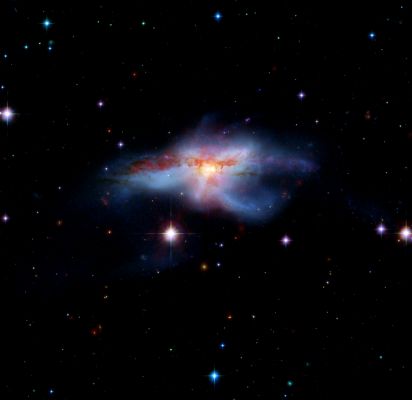 NGC 6240 - Colliding Galaxies
This image of a pair of colliding galaxies called NGC 6240 shows them in a rare, short-lived phase of their evolution just before they merge into a single, larger galaxy. The prolonged, violent collision has drastically altered the appearance of both galaxies and created huge amounts of heat turning NGC 6240 into an "InfraRed Luminous" Active Galaxy. 

A rich variety of active galaxies, with different shapes, luminosities and radiation profiles exist. These galaxies may be related astronomers have suspected that they may represent an evolutionary sequence. By catching different galaxies in different stages of merging, a story emerges as one type of active galaxy changes into another. NGC 6240 provides an important "missing link" in this process. 

This image was created from combined data from the infrared array camera of NASA's Spitzer Space Telescope at 3.6 and 8.0 microns (red) and Visible Light from NASA's Hubble Space Telescope (green and blue).
Parole chiave: From Space Images - Spitzer Space Telescope (SST)