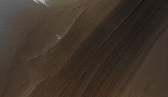 North Polar Layers (Natural Colors; credits for the additional process. and color.: Dr Paolo C. Fienga - Lunexit Team)
Caption NASA originale:"The middle portion of the Northern Summer Season is the ideal time of year to capture relatively dust- and haze-free views of Martian North Polar Terrain. 
This year, much more of the North Polar Cap has sublimed away than has been evident in previous Northern Summers going back to 1999, when MGS began the Mapping Phase of the mission. This MGS-MOC image shows a nearly ice-free view of Layers exposed by erosion in the North Polar Region. The light-toned patches are remnants of water ice frost. 
The Layers are generally considered by the Mars scientific community to be record of past depositions of ice and dust. This picture is located near 82,5° North, 118,6° West and covers an area about 3 by 10 Km (approx. 1,9 by 6,2 miles). Sunlight illuminates the scene from the upper left; the image was acquired on September, 22, 2006".
Parole chiave: Mars from orbit - Layered Terrain - North Polar Region