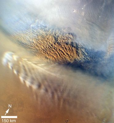Dust Storm over Utopia Planitia
This close-up image of a Dust Storm on Mars was acquired by the Mars Color Imager instrument onboard NASA's Mars Reconnaissance Orbiter on Nov. 7, 2007, around 15:00 Local Time on Mars. Scientists working with NASA's Curiosity Rover, which is set to land on Mars on Aug. 5 PDT (Aug. 6 EDT), are monitoring Mars each day for similar small Storms that could either drift over the Landing Site or stir up dust that moves as haze over the Site.
This image is centered on Utopia Planitia (53,6° North Latitude and 147,9° East Longitude), along the North Seasonal Polar Cap Edge as it is in late Northern Winter. 
When NASA's Curiosity Rover lands on Mars, it will be late Southern Winter. Scientists are looking at similar small storms that form near the South Seasonal Polar Cap Edge. The Dust Storm pictured here was short-lived, lasting less than 24 hours. The image also shows the Seasonal North Polar Cap (at the top of the frame) and gravity-wave Water-Ice Clouds coming off of Mie Crater, just South of the Storm. 
Gravity-Wave Clouds, also called "Lee-Wave Clouds", are Clouds that result from changes in Atmospheric Pressure, Temperature and height because of "Vertical Displacement", such as when Wind blows over a Mountain or a (huge) Crater Wall.

The projection of the image is Polar Stereographic and the image has a resolution of about 0,6 miles (1 Km) per pixel. North is indicated with an arrow in this image. The white scale bar is 93 miles (approx. 150 kilometers).
