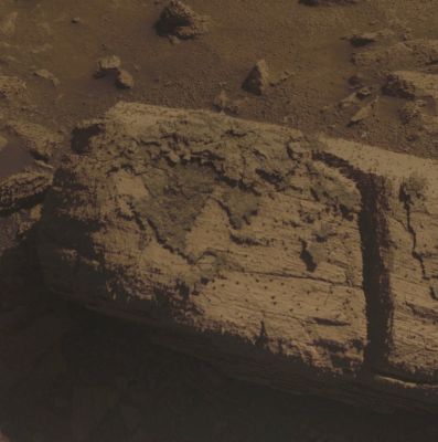 Coating on a Rock standing beside Concepci�n Crater - Sol 2150 (Natural Colors; credits: Dr Paolo C. Fienga - Lunexit Team) 
Caption NASA:"This image from the PanCam on NASA's Mars Exploration Rover Opportunity shows a rock called "Chocolate Hills", which the Rover found and examined at the edge of a young crater called "Concepción".
The rover used the tools on its Robotic Arm (RA) to examine the texture and composition of target areas on the rock with and without the dark coating. The rock is about the size of a loaf of bread. Initial analysis was inconclusive about whether the coating on the rock is material that melted during the impact event that dug the Crater.

This view is presented in Natural Color, which makes some differences between materials easier to see. It combines three separate images taken through filters admitting wavelengths of 750 nanometers, 530 nanometers and 430 nanometers. Opportunity took the image during the 2147nd Martian Day, or Sol, of the Rover's Mission on Mars (such as Feb. 6, 2010)".
Parole chiave: Martian Surface - Coated Rock