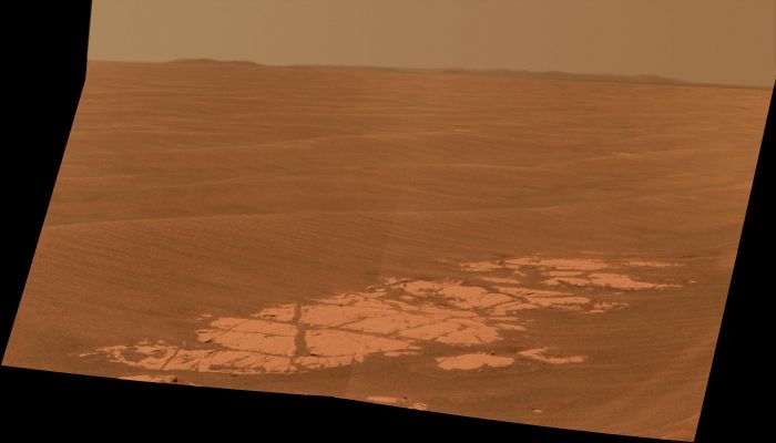 Endeavour! - Sol 2226 (Approx. True Colors; credits: NASA/JPL-Caltech/Cornell University)
Caption NASA:"NASA's Mars Exploration Rover Opportunity used its Panoramic Camera (Pancam) to capture this view of the Outer Rim of Endeavour crater, the Rover's destination in a multi-year traverse along the sandy Martian landscape. The image was taken during the 2226th Martian Day, or Sol, of Opportunity's mission on Mars (such as April, 28, 2010).
Endeavour is about 21 Km (approx. 13 miles) in diameter, such as about 25 times wider than Victoria, the last major crater that Opportunity visited. This image shows an outcrop of rocks at the foot of the Rover and, beyond these rocks, Rippled Dunes, which are about 20 cm (8") tall. 
The Outer West Rim of Endeavour, about 13 Km (approx. 8 miles) away, appears on the left on the horizon. 
The Rim of smaller, more-distant Iazu Crater, which is about 7 Km (approx. 4 miles) in diameter and about 35 Km (approx. 22 miles) away, is on the far right. On the horizon in between is a blanket of material ejected from the impact that created Iazu Crater, and darker features that are portions of the West and South/Western Rim of Endeavour. 

Opportunity began a marathon from Victoria to Endeavour in September 2008 after spending two years exploring Victoria. The intended route, about 19 Km(such as approx. 12 miles) long, has headed South before turning East in order to bypass potentially hazardous Sand Ripples, larger than the Ripples in this image. 

This Approximately True-Color View combines three exposures taken through filters admitting wavelengths of 750 nanometers, 530 nanometers and 430 nanometers".
Parole chiave: Martian Horizon - Meridiani Planum