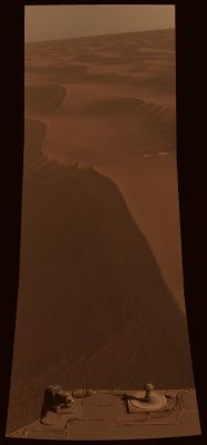 Meridiani Planum - Sol 2229 (Natural Colors; credits: NASA/JPL-Caltech/Cornell University)
While humans' lives unfolded on Earth, NASA's Mars Exploration Rover Opportunity paused in its Southward trek and captured this photomosaic around 15:00 MLT on May 2, 2010. The timing for this photography with Opportunity's Panoramic Camera (PanCam) was coordinated with a "moment in time" simultaneous photographic event in thousands of locations on Earth, organized through New York Times photography blog, Lens. (See http://lens.blogs.nytimes.com/2010/05/04/readers-14/.)
Dusty, reddish-brown Dunes stretch Southward to the horizon along the Rover's route ahead.

The "Two Worlds, One Sun" theme is a reference to the motto inscribed on the PanCam Calibration Target, seen on the back of the Rover Deck at the bottom of this view. The Target is used to properly calibrate and color-balance the PanCam images, and with its artistically styled shadow post, or Gnomon, it doubles as a Sundial (also known as a "Marsdial") for educational purposes. (See also PIA05018.)

This scene is a three-tall by one-wide mosaic of PanCam images taken through the camera's red (602 nanometer), green (530 nanometer) and blue (480 nanometer) filters. It has been calibrated and processed to approx. the colors that would be seen by humans if they could be present for this lovely Martian view. The camera took the images during the 2229th Martian Day, or Sol, of Opportunity's mission.
Parole chiave: Martian Horizon - Meridiani Planum