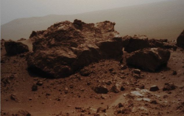 Rocky Outcrop ("Rideout") near the Edge of Endeavour Crater - Sol 2685 (Absolute Natural Colors; credits for the additional process. and color: Dr Paolo C. Fienga - Lunexit Team)
Caption NASA:"NASA's Mars Exploration Rover Opportunity looked across a small Unnamed Crater on the Rim of a much larger one to capture this raw image from its PanCam during the Rover's 2685th Martian Day, or Sol, of work on Mars (Aug. 13, 2011). 
Opportunity had arrived at the Western Rim of the about 13-mile-diameter (approx. 21-Km-diameter) Endeavour Crater four days earlier. A portion of the N/E Rim of Endeavour forms the distant horizon in this view. An Unnamed Crater about 66 feet (approx. 20 meters) in diameter is on the Endeavour Rim near Opportunity's arrival point. From a position South of Odyssey, this view is dominated by a rock informally named "Ridout" on the N/E Rim of Odyssey. The rock is roughly the same size as the Rover, which is 4,9 feet (such as 1,5 meters) long".
Parole chiave: Martian Surface - Rocks - Rideout