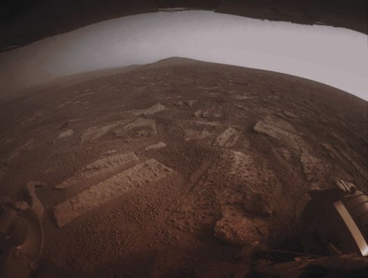 Southward View (White-Balanced Natural Colors; credits for the additional process. and color.: Dr Paolo C. Fienga/Lunar Explorer Italia/Italian Planetary Foundation)
This very suggestive picture shows us some of the Terrain that the NASA - Mars Exploration Rover (MER) Opportunity is crossing in a (always relatively speaking) flat area of Endeavour Crater, called "Botany Bay", and located on the way toward "Solander Point," which is visible on the horizon.

The NASA - Mars Exploration Rover (MER) Opportunity used its Rear Hazard-Identification Camera (or HazCam, for short) to record this Southward view at the end of a drive covering about 387 feet (such as a little less than 118 meters) and which took place on the 3.355th Martian Day (or Sol) of Opportunity's work on Mars (such as July, 2nd, 2013 on Earth). Rover planners have been driving Opportunity in reverse, with the aim of to mitigatating a little bit the normal wearand tear on the Front - and so-called - "Wheel Actuators". For scale, the distance between the two Rear Wheels visible in the foreground is about 3,3 feet (a little more than 1 meter). The underside of Opportunity's Deck is visible at the top of the image. The Surface that the Rover (MER) Opportunity is driving upon, while crossing Botany Bay, is a Mosaic Pavement of fractured, light-toned Bedrock (---> the so-called "Martian Paving" of Meridiani Planum). A mixture of dark-toned Basaltic Soil and small Spherules - nicknamed "Blueberries" - fills-up most of the Cracks existing between the Bedrock pieces and, here and there, also thinly covers some of the Bedrock itself. 

This frame (which is an Original NASA - Mars Exploration Rover (MER) "Opportunity" b/w image published on the NASA - Planetary Photojournal and identified by the ID n. PIA 17271) has been additionally processed, magnified and then colorized in White-Balanced Natural Colors (such as the colors that a normal - meaning "in the average" - human eye would actually perceive if someone were on the Surface of Mars, near the NASA - Mars Exploration Rover (MER) Opportunity, and then looked ahead, towards the Horizon and Sky over Endeavour Crater), by using an original technique created - and, in time, dramatically improved - by the Lunar Explorer Italia Team.
Parole chiave: Martian Horizon - Meridiani Planum - Solander Point