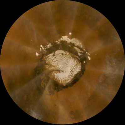 Dust Storm in the North Polar Regions
Caption NASA:"This is an image of Mars taken from orbit by the Mars Reconnaissance Orbiter's Mars Color Imager (MARCI). The Red Planet's Polar Ice-Cap is in the middle of the image. Captured in this image is a 37.000 square-kilometer (almost 23.000 miles) Dust Storm that moved counter-clockwise through the Phoenix Landing Site on Oct 11, 2008, or Sol 135 of the Mission. 

Viewing this image as if it were the face of a clock, Phoenix is shown as a small white dot, located at about 10 AM. The storm, which had already passed over the Landing Site earlier in the day, is located at about 9:30 AM".
Parole chiave: Mars from orbit - North Polar Regions