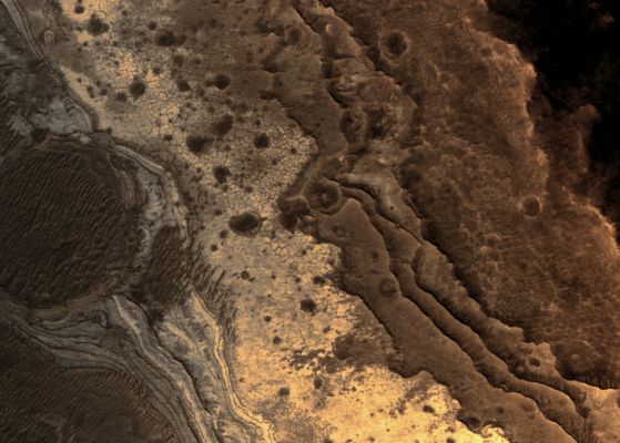 Martian "Opal" (natural colors; credits: Lunexit)
NASA's Mars Reconnaissance Orbiter has revealed Martian rocks containing a hydrated mineral similar to Opal. 

The rocks are light-toned and appear cream-colored in this natural-color image taken by the High Resolution Imaging Science Experiment (HiRISE) camera. Images acquired by the orbiter reveal that different layers of rock have different properties and chemistry. 
The Opal minerals are located in distinct beds of rock outside of the large Valles Marineris Canyon System and are also found in rocks within the canyon. The presence of opal in these relatively young rocks tells scientists that water, possibly as rivers and small ponds, interacted with the surface as recently as two billion years ago, one billion years later than scientists had expected. 

The discovery of this new category of minerals spread across large regions of Mars suggests that liquid water played an important role in shaping the Planet's Surface and possibly hosting life. 
Parole chiave: Mars from orbit - Valles Marineris Canyon System