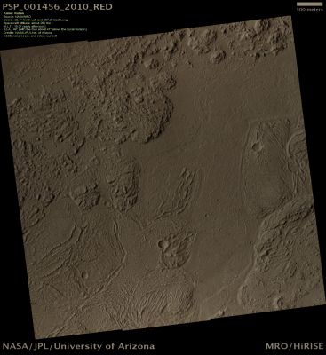 Flood-carved Canyon in Kasei Valles (Natural Colors; credits: Lunexit)
This HiRISE image shows a wonderfully complex surface on the floor of this ancient Flood-carved Canyon.

The floor of this Canyon, now, does not show any kind of landform that scientists expect to see from the occurrence of flood erosion phenomena. 
Instead, it appears that the floor of the valley has been covered, after the inundation that first designed it, by another flow made by some very dense material that also contained huge ridged plates. 

Some of the plates are more than 1 Km (0,6 miles) across. The ridges appear to have formed when the solid crust on the flow crumpled; the plates are pieces of the crust that were rafted apart. 
Actually, very large Lava Flows can produce a surface like this, but also water-ice and frozen mud can create similar features.
Parole chiave: Mars from orbit - Kasei Valles