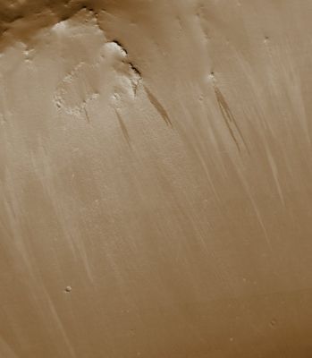 Slope Streaks in Terra Sabaea (EDM - Natural Colors; credits: Dr Paolo C. Fienga - Lunexit Team)
This EDM is a close-up view of the Crater Rim revealing dark and light-toned Slope Streaks. Slope Streaks' formation is among the few known processes currently active on Mars. While their mechanism of formation and triggering is debated, they are most commonly believed to form by downslope movement of extremely dry sand or very fine-grained dust in an almost fluidlike manner (analogous to a terrestrial snow avalanche) exposing darker underlying material. 
Other ideas include the triggering of Slope Streaks' formation by possible concentrations of near-Surface ice or scouring of the Surface by running water from aquifers intercepting slope faces, Spring Discharge (perhaps brines) and/or hydrothermal activity.

Several of the Slope Streaks seen here, particularly the 3 longest darker Streaks, show evidence that downslope movement is being diverted around obstacles such as large boulders. Several Streaks also appear to originate at boulders or clumps of rocky material.
In general, the Slope Streaks do not have large deposits of displaced material at their downslope ends and do not run out onto the Crater Floor suggesting that they have little reserve kinetic energy. The darkest Slope Streaks are the youngest and can be seen to cross cut and superpose older and lighter-toned Streaks. 
The lighter-toned streaks are believed to be dark streaks that have lightened with time as new dust is deposited on their surface.
Parole chiave: Mars from orbit - Slope Streaks - Terra Sabaea